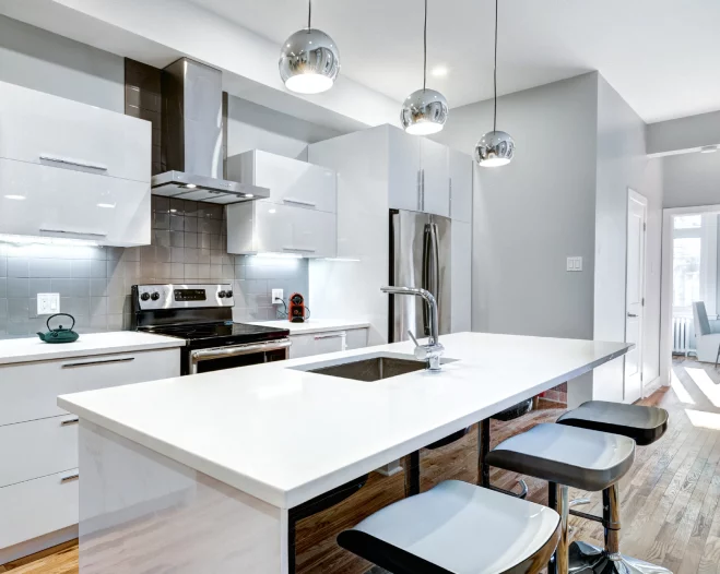 modern white theme kitchen with hanging lights above countertop
